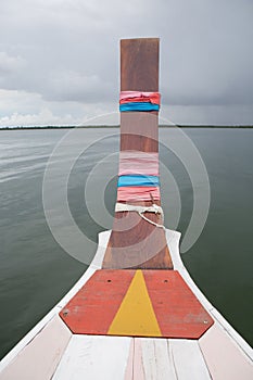 Thai wooden head longtail boat heads toward the tropical Andaman