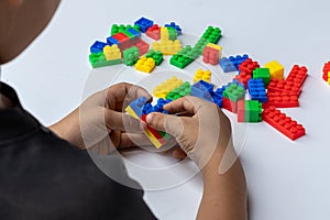 Thailand, bangkok. April 27, 2020. Children hands play with colorful lego blocks on white background.