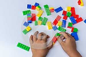 Thailand, bangkok. April 29, 2020. Children hands play with colorful lego blocks on white background.