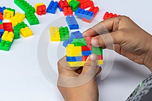 Thailand, bangkok. April 29, 2020. Children hands play with colorful lego blocks on white background.