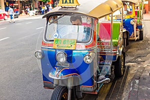 Thailand, Bangkok -Feb 02, 2019: Tuk tuk or taxi driver parking his car beside the road at siamsquare while another motion blur