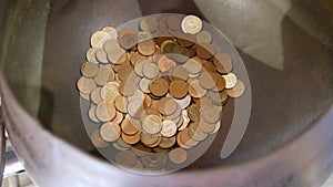 Thailand coins offered at a temple in Bangkok, Thailand