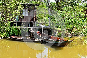 Thailand country house style in the garden beside river with boats