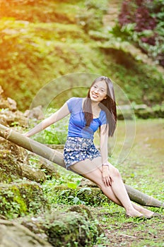 Asian girl sit down path in Bamboo forest