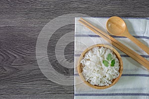 White rice, cooked white rice, cooked plain rice in wooden bowl with spoon and chopsticks, Organic rice on the rustic wooden