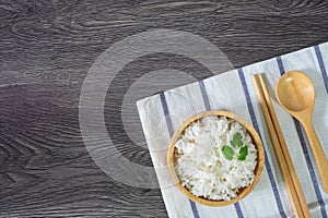 White rice, cooked white rice, cooked plain rice in wooden bowl with spoon and chopsticks, Organic rice on the rustic wooden