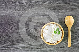 White rice, cooked white rice, cooked plain rice in wooden bowl with spoon and Organic rice on the rustic wooden background