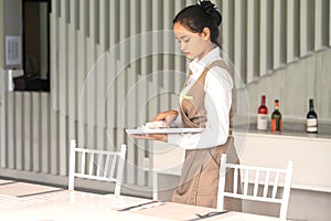 Thailand, Khaolak, 20 july 2019: Waitress asian against empty tableware, table setting