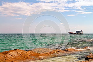 Thailand Koh Samet Old Style Ship near Rocky shore