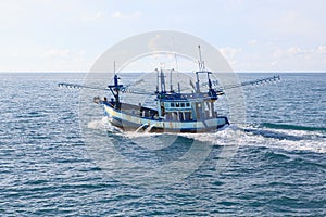 Thailand local fishery boat running over blue sea water