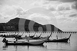 Thailand longtail fishing boat at Chalong bay. Phuket. Black and white