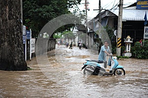 Thailand Monsoon , People walking through flood