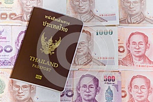 Thailand passport with background thai baht banknotes and coins