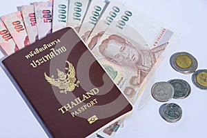Thailand passport with isolated white background baht banknotes