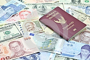 Thailand passport on mixed currency banknotes