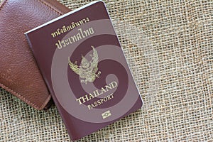 Thailand passport with Wallet on sack background