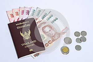 Thailand passport with white background baht banknotes and coins