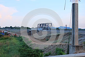 Thailand railway tracks feature cobbles, red dirt roads and workers' homes.  Beautiful sky view background