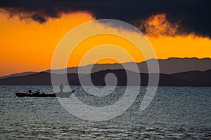 Thailand sea in twilight time with Silhouette ship and fisherman in the sea