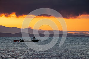 Thailand sea in twilight time with Silhouette ship and fisherman in the sea