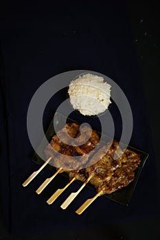 Thailand traditional cuisine, Grilled pork, Moo ping, Street food, dark food photography, sticky rice, pork stick, street food