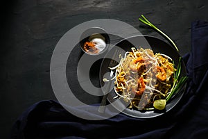 Thailand traditional cuisine, Pad thai, dried noodle, fried noodles, shrimp and seafood, street food, dark food photography