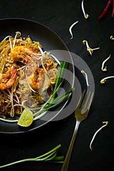 Thailand traditional cuisine, Pad thai, dried noodle, fried noodles, shrimp and seafood, street food, dark food photography