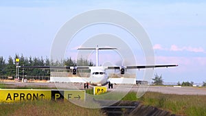 Thailland. Phuket International Airport. Airfield. Propeller, twin-engine aircraft start engines. Slow Motion.