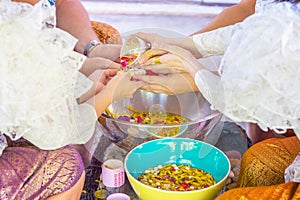 Thais celebrate Songkran in new year water festival by young people pour water to elder seniors and asked for blessings.