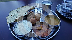 Thali with roti, rice, dal, sabzi, curry and curd - authentic Indian food