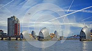 Thames Barrier in London, with PLANE TRACKS AND PLANE