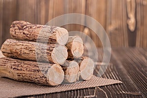 Thanaka wood on wooden plank background