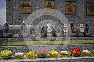 Thangka, essential oil plates, flowers, offerings on a granite Buddhist stupa