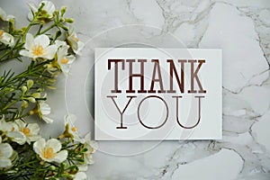 Thank you card with flower bouquet decoration top view on marble background