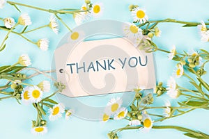 Thank you card surrounded by flowers, being thankful, support, help and charity concept, positive attitude