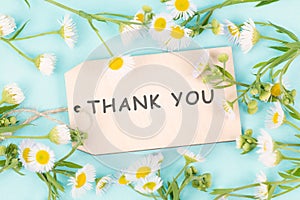 Thank you card surrounded by flowers, being thankful, support, help and charity concept, positive attitude