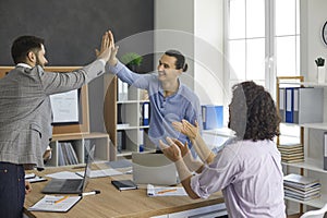 Two men make business deal and give high five to each other after negotiation meeting