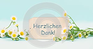 Thank you in german language, card surrounded by flowers, being thankful, support, help and charity, positive attitude