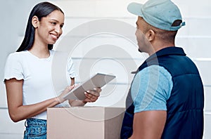 Thank you for getting this to me so quickly. Shot of a young woman using a digital tablet to sign for her delivery from