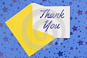 Thank you greeting card with yellow envelope on stars