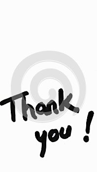 Thank you handwriting text close up isolated on white paper with copy space. Writing text on memo post reminder