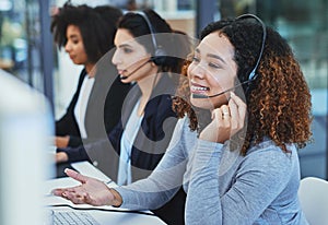 Thank you for holding, how may I assist. young women working in a call centre.