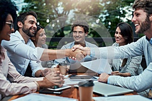 Thank you for joining us. businesspeople shaking hands during a meeting at a cafe.