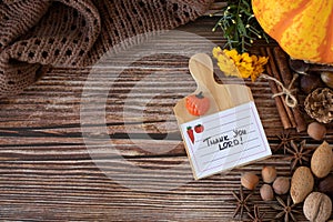 Thank You, LORD, handwritten text note on wooden background with pumpkin, nuts, and Bible Book, copy space, top view