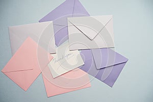 thank you message on colorful envelope on table