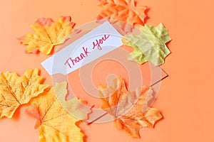 Thank you message and envelope on orange background