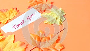 Thank you message and envelope on orange background