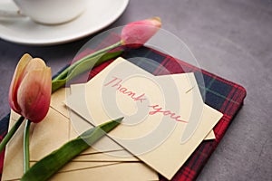 thank you message, envelope tulip flower on table