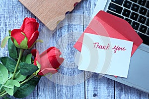 thank you message and envelope on wooden table