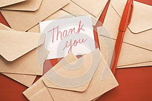 thank you message and envelope on wooden table